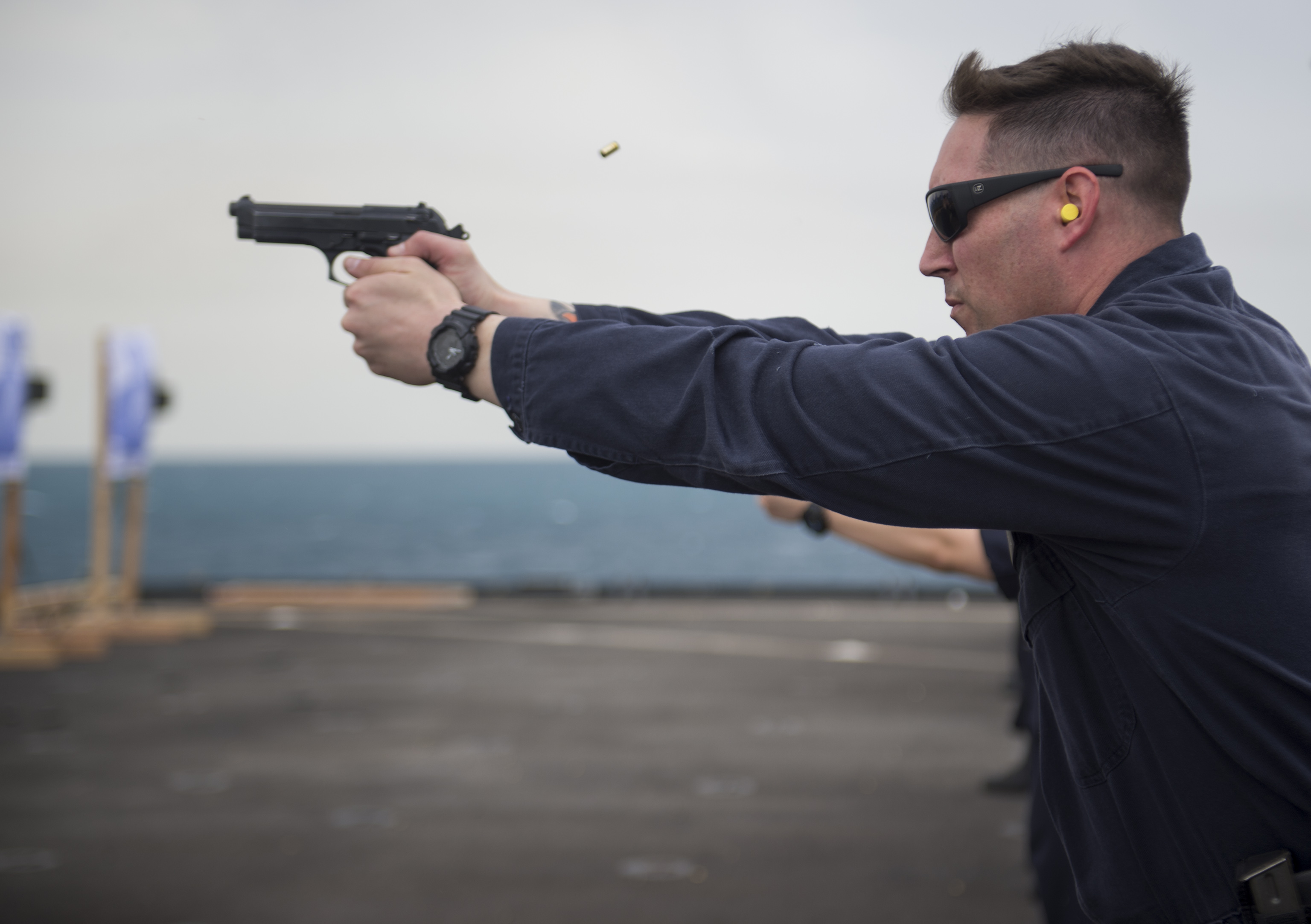 9mm vs 45 man firing a gun