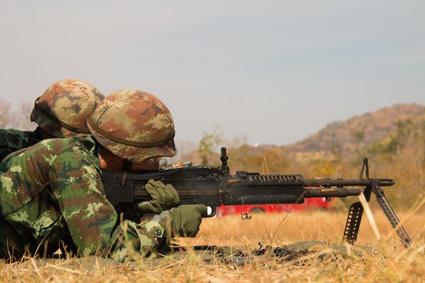 armed man shooting a gun